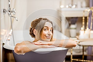 Woman bathing at the retro bathroom