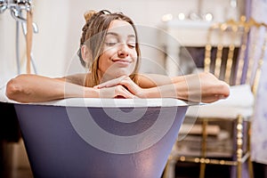 Woman bathing at the retro bathroom