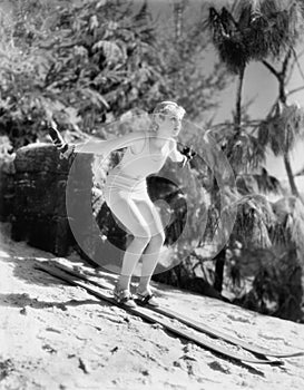 Woman In a bathing suit skiing down a hill