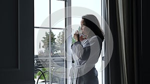 Woman in Bathrobe Talking by Phone at Hotel Room