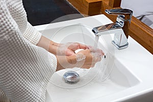 Woman in a bathrobe is washing hands,Hygiene. Cleaning Hands. Wa