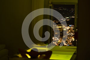 Woman in the bathroom at the hotel enjoying the view of the night city