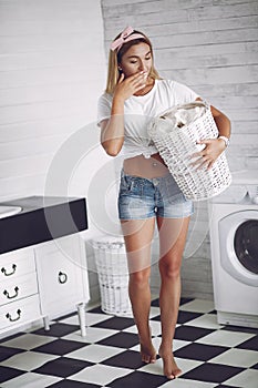 Woman in a bathroom near wash mashine