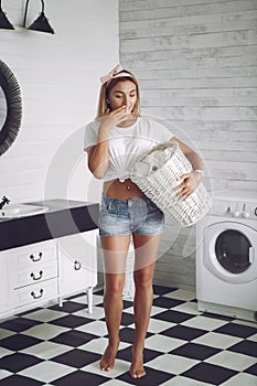 Woman in a bathroom near wash mashine