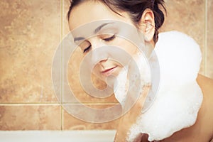 Woman in bathtub full of foam
