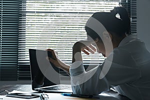 A woman battles depression and stress in her workplace, highlighting the challenges faced by professionals. This image captures