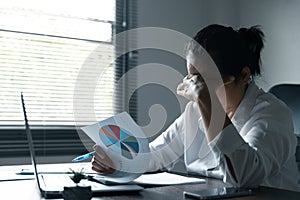 A woman battles depression and stress in her workplace, highlighting the challenges faced by professionals. This image captures