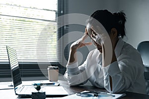 A woman battles depression and stress in her workplace, highlighting the challenges faced by professionals. This image captures