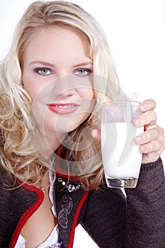 Woman in Bavarian outfit and drinking a milk