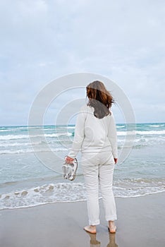 Woman on beach against sea and sky.