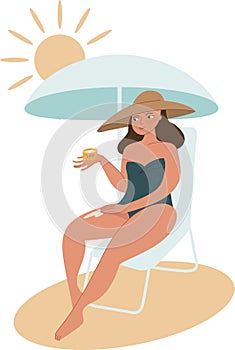 A woman at the beach applies sunscreen to her skin under a sunshadow. Sun protection concept. Healthy tanning