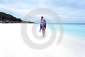 Woman on beach with Aussie flag draped around her