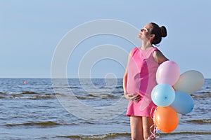 Woman on beach with balloons