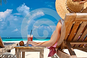 Woman at beach with chaise-lounges