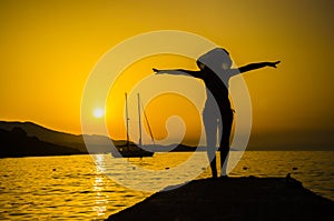 Woman on the beach doing king dancer pose