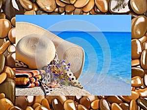 Woman beach hat, bright towel and flowers against blue ocean