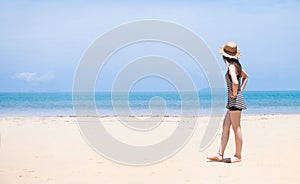 woman and beach hat on tropical beach