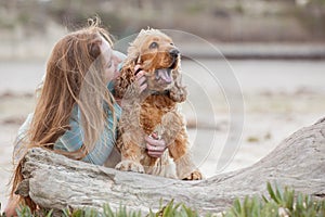 A woman on the beach with her Chocker Spaniel