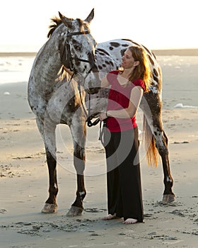Woman on the beach with horse