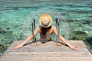 Woman on a beach jetty at Maldives