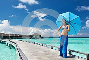 Woman on a beach jetty at Maldives