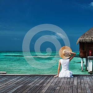 Woman on a beach jetty at Maldives