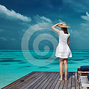 Woman on a beach jetty at Maldives