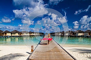 Woman on a beach jetty at Maldives