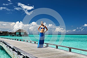 Woman on a beach jetty at Maldives