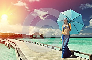 Woman on a beach jetty at Maldives