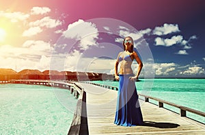 Woman on a beach jetty at Maldives