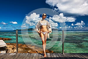 Woman on a beach jetty at Seychelles, La Digue.