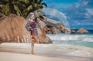 Woman on the beach in large stones