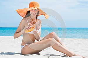 Woman At Beach With Moisturizer photo