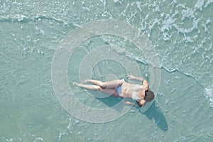 Woman on beach from overhead