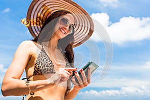 Woman on beach with phone chatting