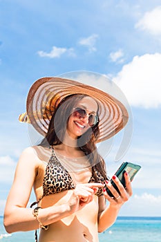 Woman on beach with phone chatting