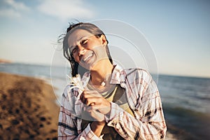 Woman on the beach. Portrait of the beautiful girl, the wind fluttering hair