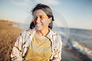 Woman on the beach. Portrait of the beautiful girl, the wind fluttering hair
