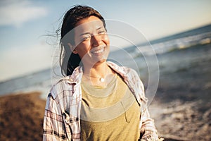 Woman on the beach. Portrait of the beautiful girl, the wind fluttering hair