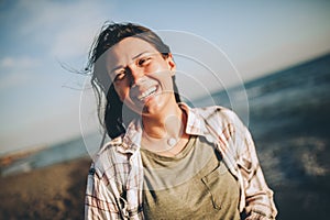 Woman on the beach. Portrait of the beautiful girl, the wind fluttering hair