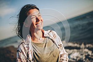 Woman on the beach. Portrait of the beautiful girl, the wind fluttering hair