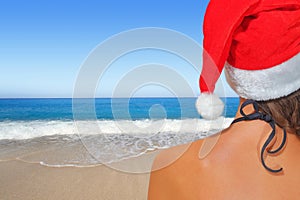 Woman on the beach in santas hat photo