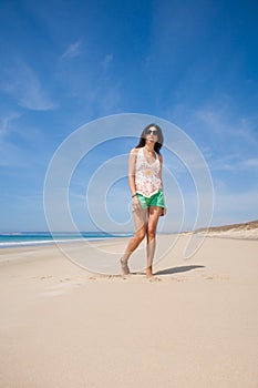 Woman in beach sticking out tongue