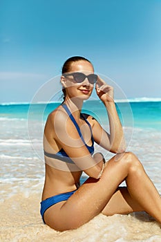 Woman On Beach In Summer. Happy Female Model Tanning