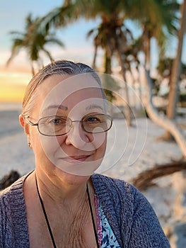 Woman on beach at sunrise