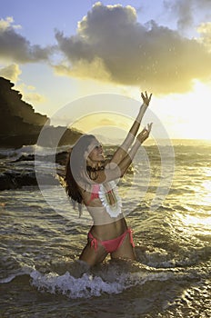 Woman on beach at sunrise