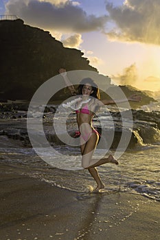 Woman on beach at sunrise