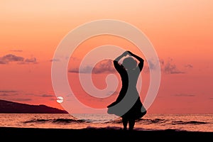Woman at beach, during sunset, silhouette