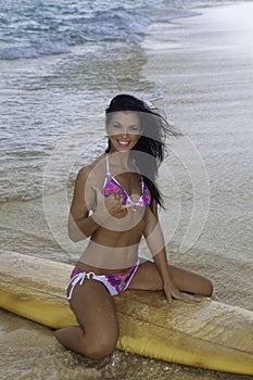 Woman on the beach with surfboard